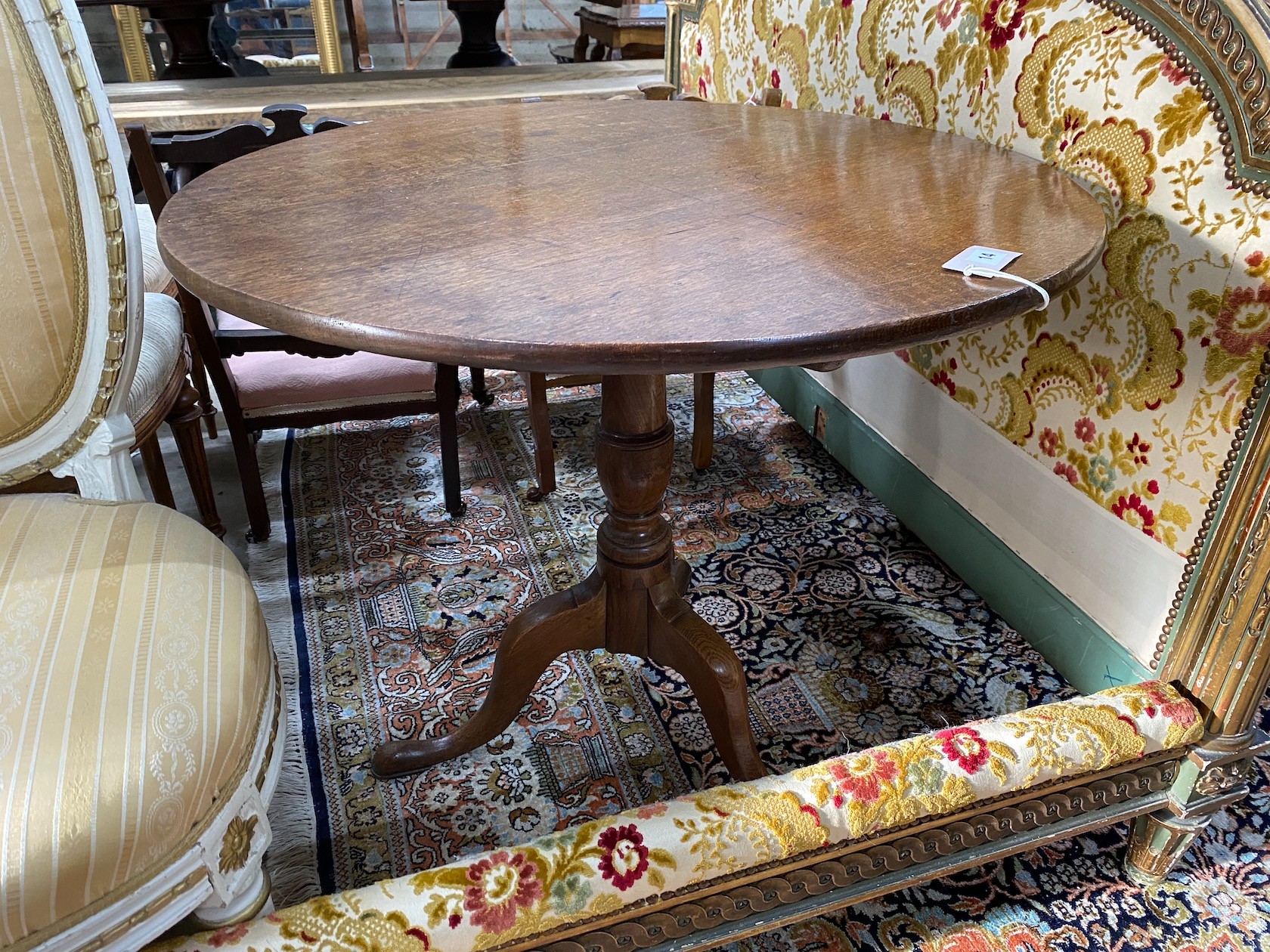 A George III oak circular tilt top tea table, diameter 82cm, height 72cm